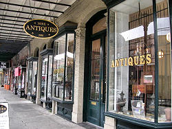looking at antique store windows down sidewalk