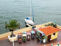 sailboat and vendors from pier upper deck