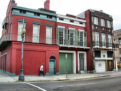 man walking on street in front of old building