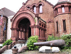 canon in front of old brick building