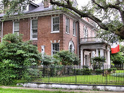 brick home behind fence