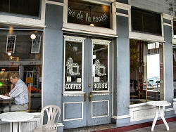 man in window of coffee shop