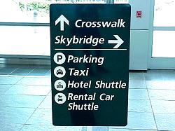 sign to crosswalk, skybridge, parking, taxi, hotel, car rental