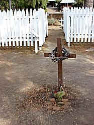 simple grave with wooden cross