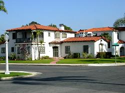 three level Spanish home with tile roof