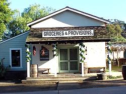 onld wooden store with sign Groceries & Provisions